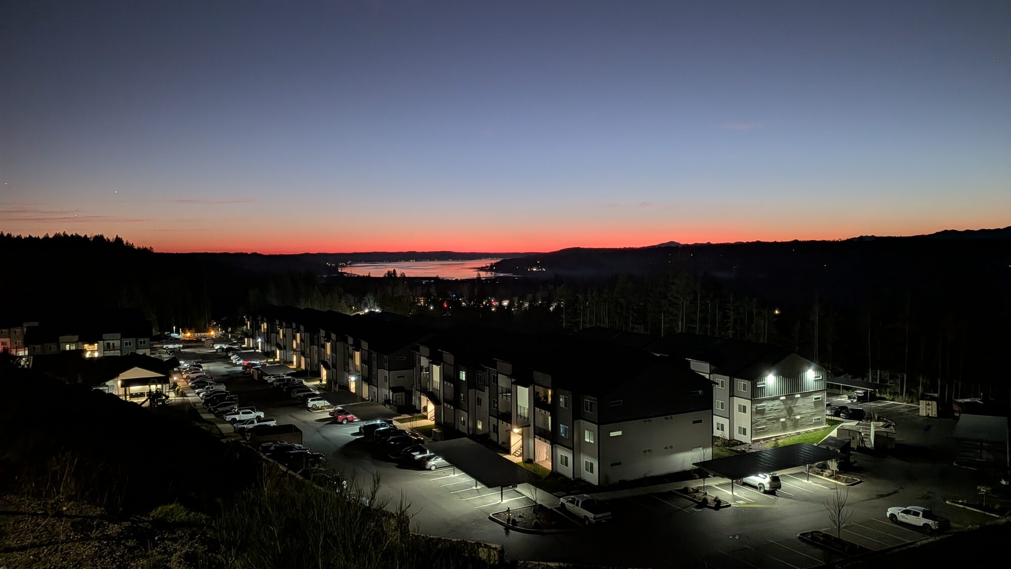 Olympic Ridge lit up after dark with a red band of afterglow over Hood Canal